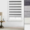 Day and night roller blind fitted to a white window frame, with five fabric colour samples