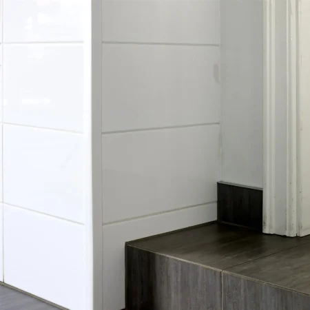 White PVC Corner Protector on a Tiled External Corner, 1m White PVC wall corner protector trim fitted to an external corner of white tiles