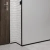 Black PVC Corner Protector Fitted to an External Wall Corner, 1m Black PVC wall corner protector trim installed on an external wall corner in a hallway