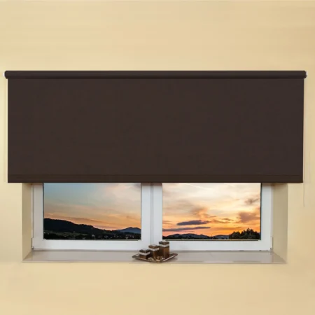 Dark brown light filtering roller blind fitted above a recessed window, sunset view