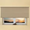 Beige light filtering roller blind fitted above a recessed window, with a sunset view