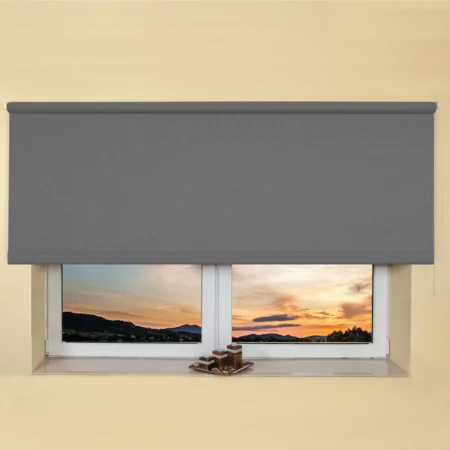 Grey light filtering roller blind fitted above a recessed window, with a sunset view