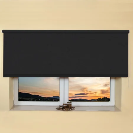 Black light filtering roller blind fitted above a recessed window, with a sunset view