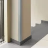 Dark Gray PVC Corner Protector on a Wall Pillar, 1m Angle Trim Dark Gray PVC wall corner protector trim installed on a wall pillar, elevator lobby