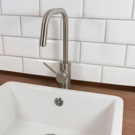 Self-adhesive PVC skirting board trim fitted in a room setting
