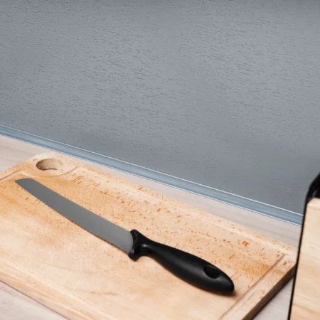 Self-adhesive PVC skirting board trim fitted in a room setting